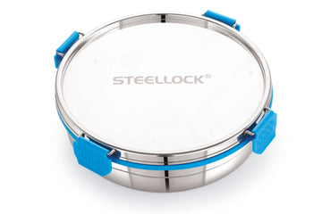 A round stainless steel Steellock Pro container with a blue silicone seal and a transparent lid.