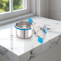Stainless steel food container with blue straps on a marble surface