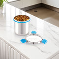 Stainless steel pet food container with blue sealing rings on a kitchen counter.