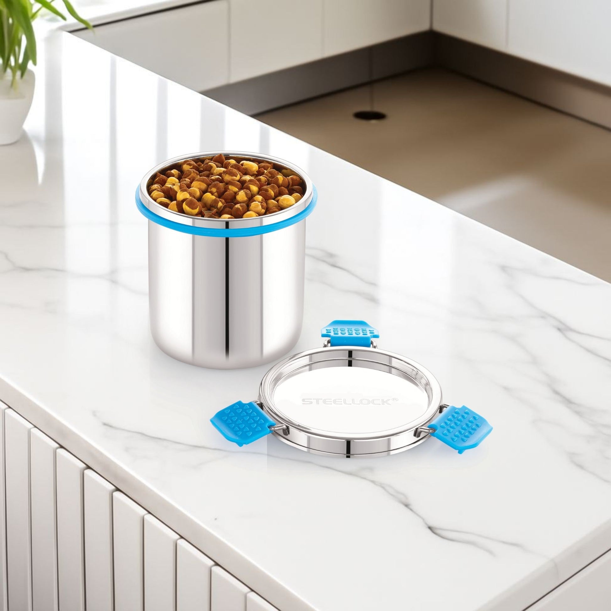 Stainless steel pet food container with blue sealing rings on a kitchen counter.