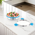 Stainless steel kitchen sink with a salad on a white countertop