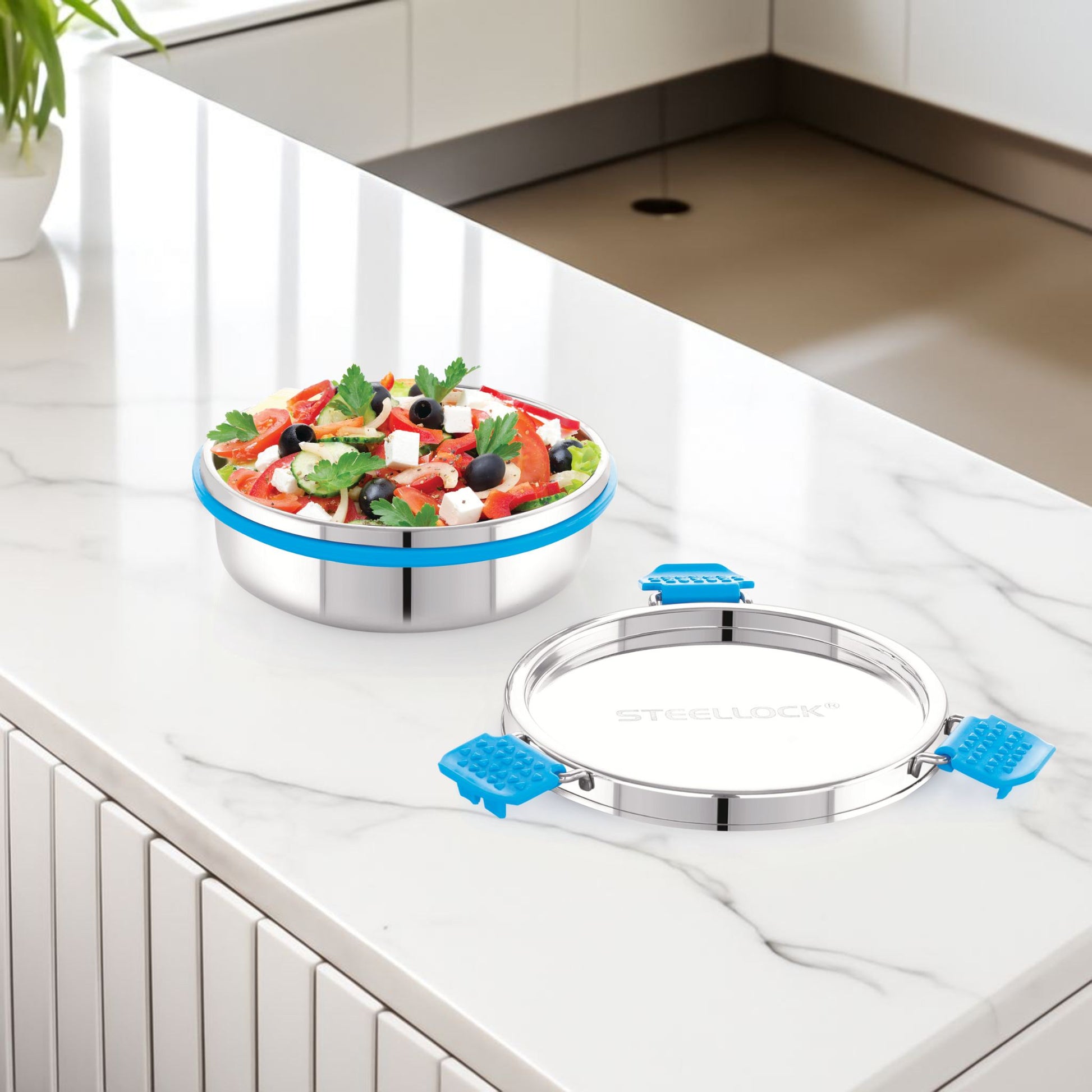 Stainless steel kitchen sink with a salad on a white countertop