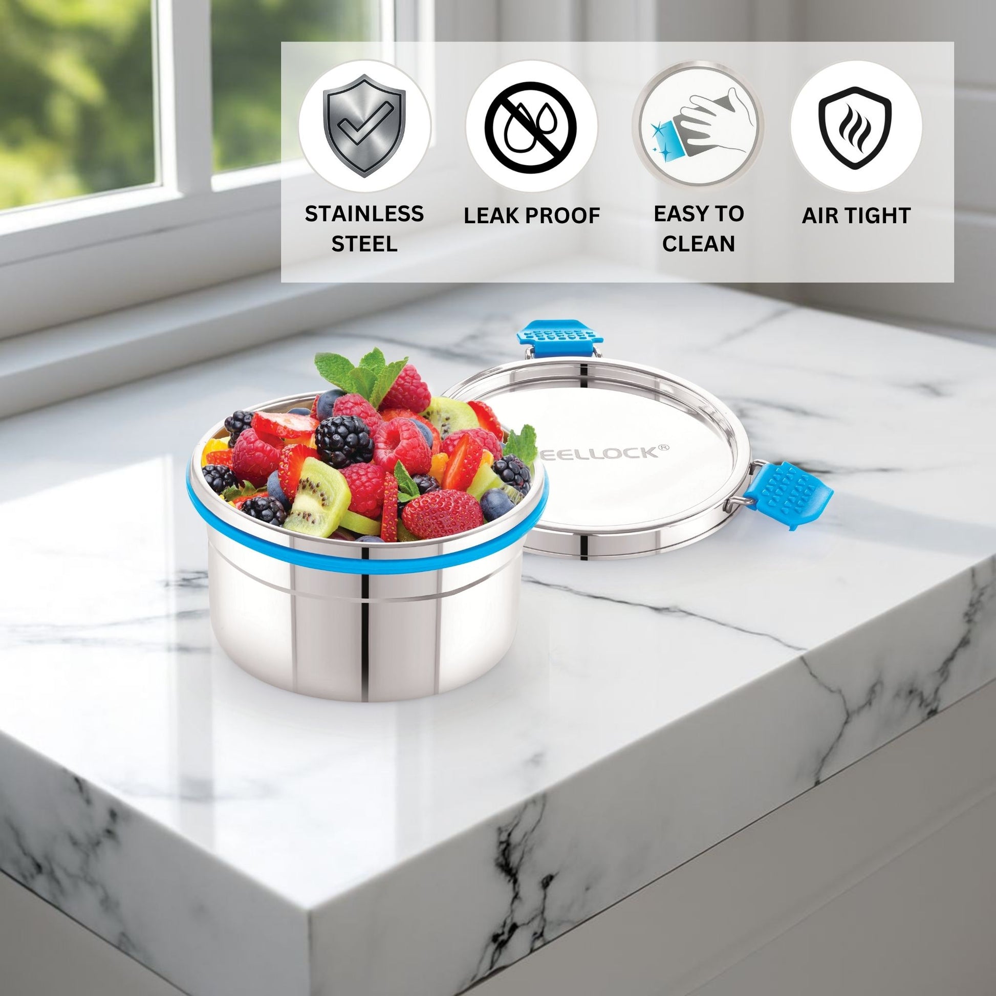 Stainless steel container with fruits on a marble surface, featuring lockable lid.