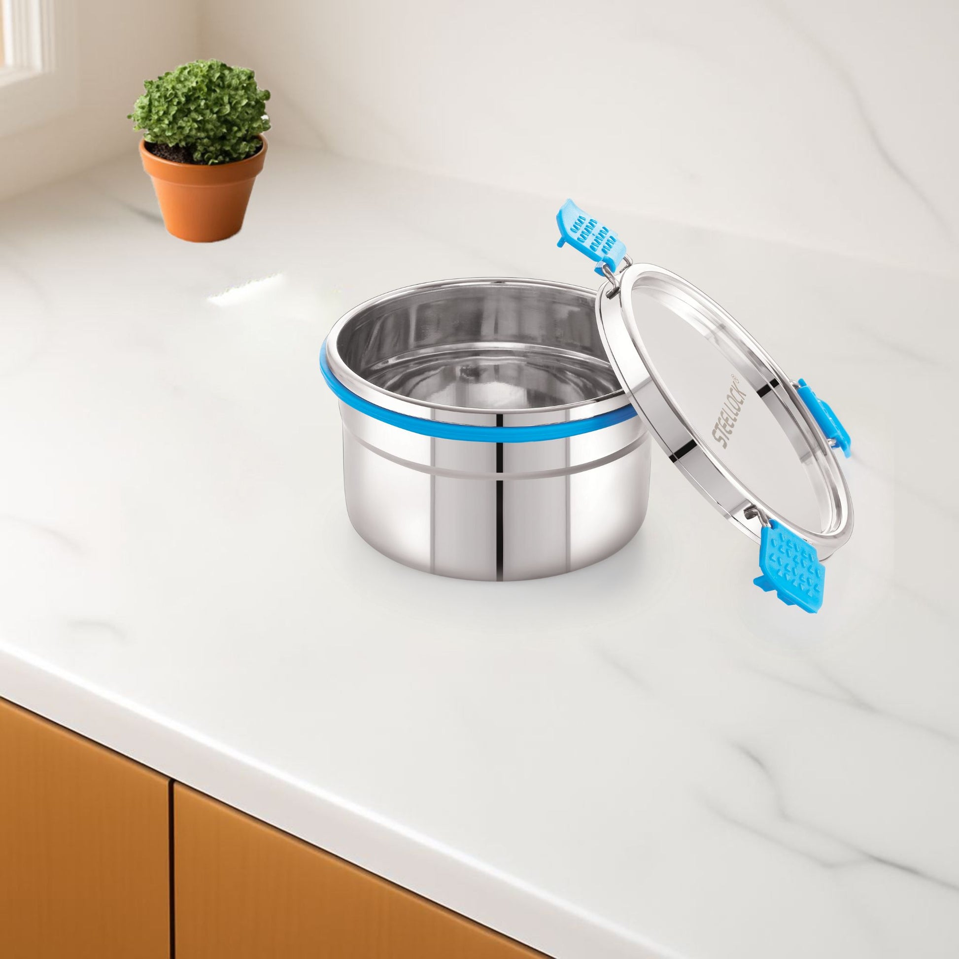 Stainless steel container with blue accents on a kitchen counter