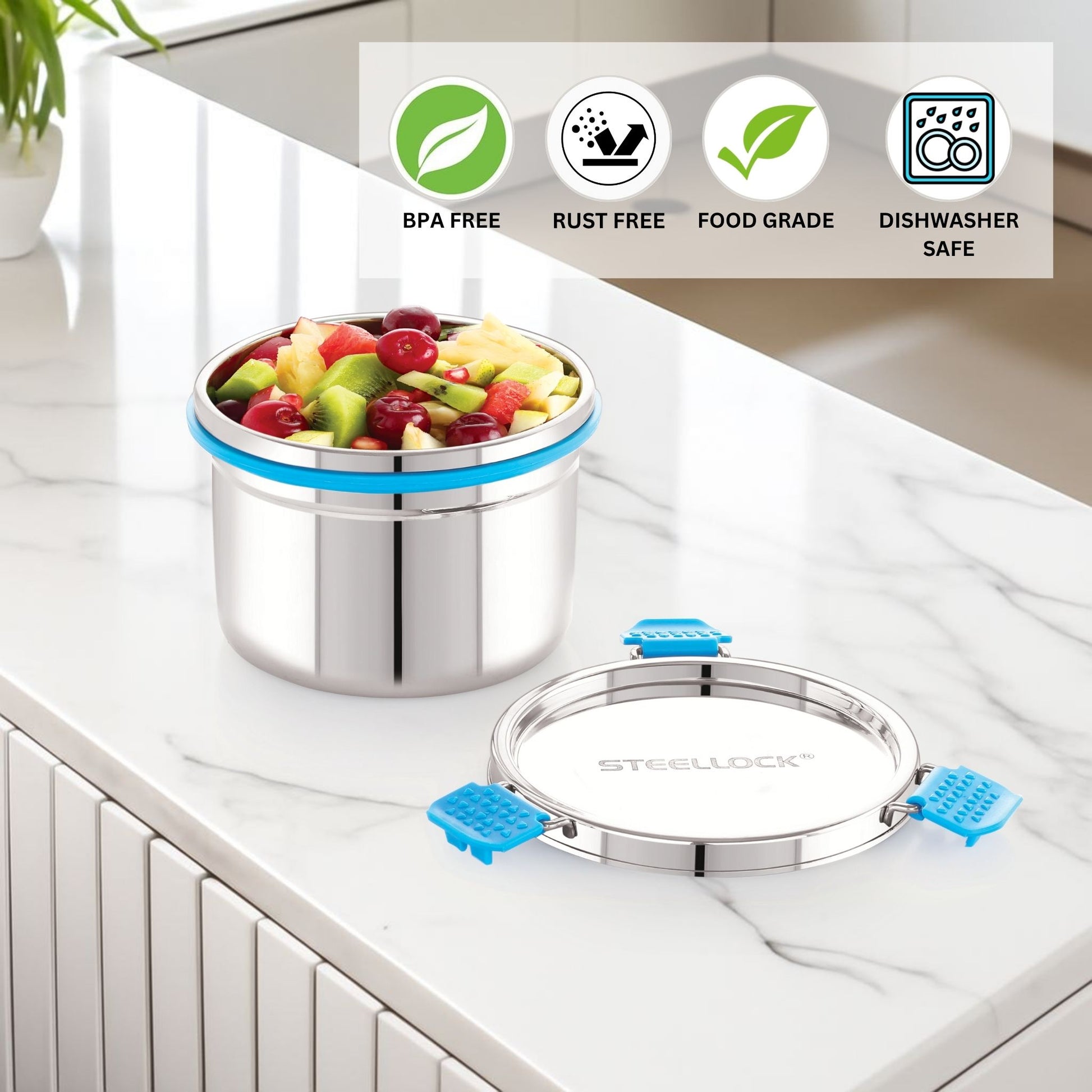 Stainless steel container with fruit on a kitchen counter, featuring safety certification icons.