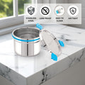 Stainless steel container with lid on a marble surface, featuring icons and text about material properties.
