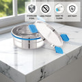 Stainless steel container with blue straps on a marble surface, featuring icons and text about material properties.