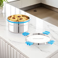 Stainless steel food container on a kitchen counter, featuring the brand 'Steelock'.