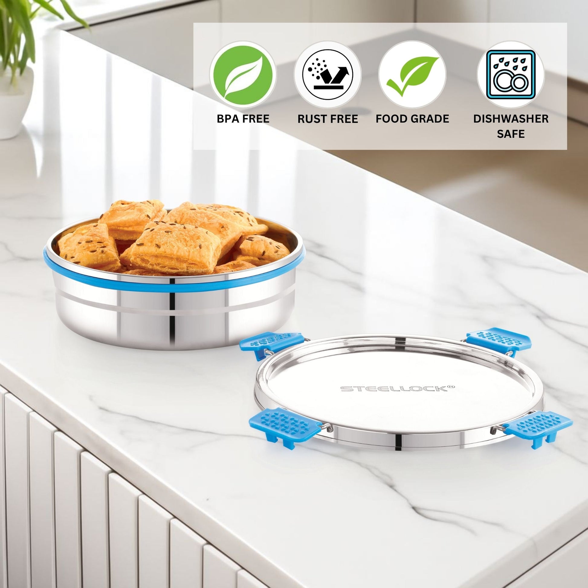 Stainless steel food container with blue accents on a kitchen counter, featuring BPA-free, rust-free, food-grade, and dishwasher-safe icons.