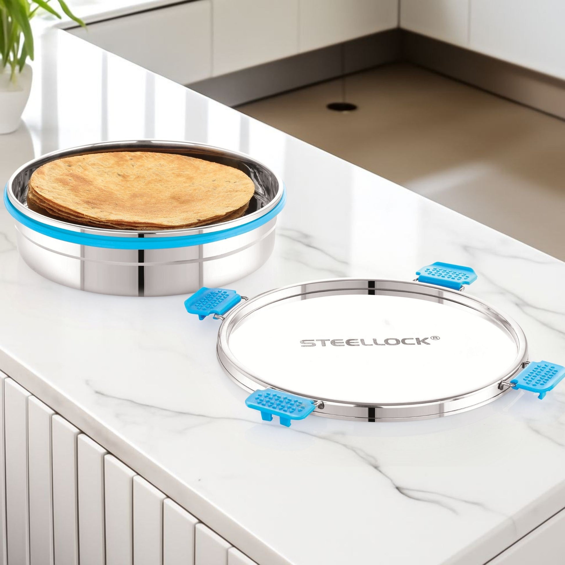 Stainless steel tortilla press with tortillas on a kitchen counter, featuring the brand 'Steellock'.
