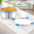 Stainless steel container with lid on a kitchen counter, featuring 'Steellock' brand.