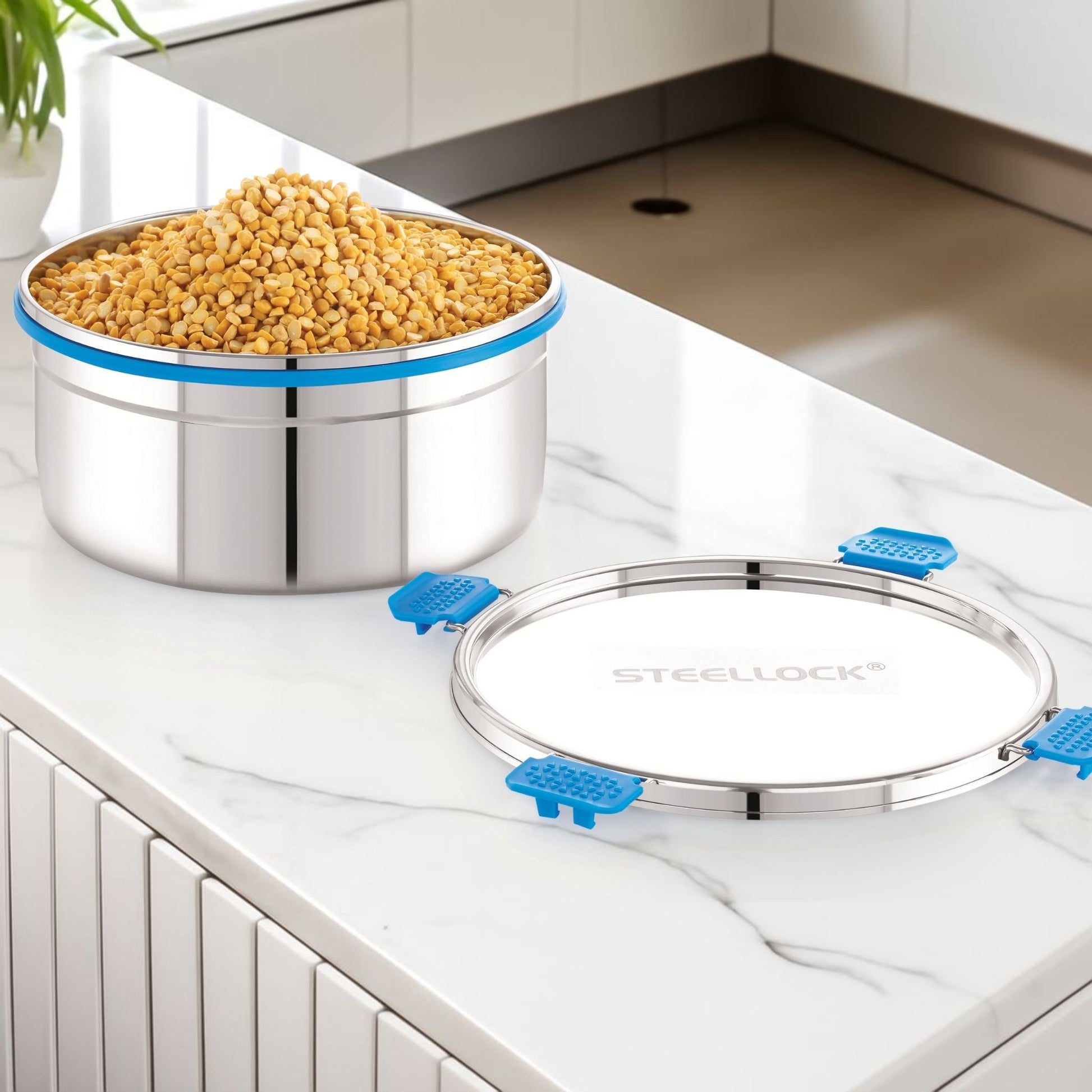 Stainless steel container with lid on a kitchen counter, filled with grains.